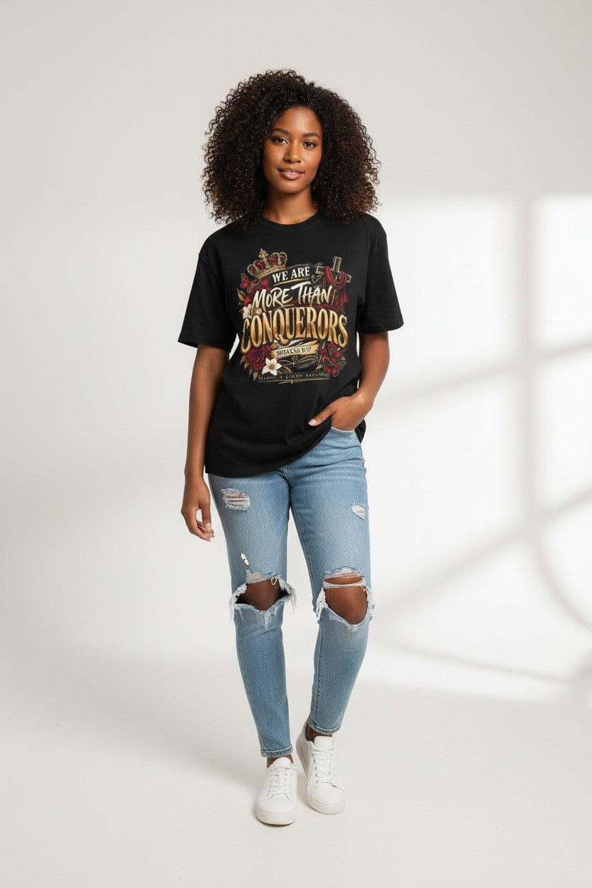 StatementCentralCo black graphic crewneck t-shirt with More Than Conquerors text, crown, and floral design on a model